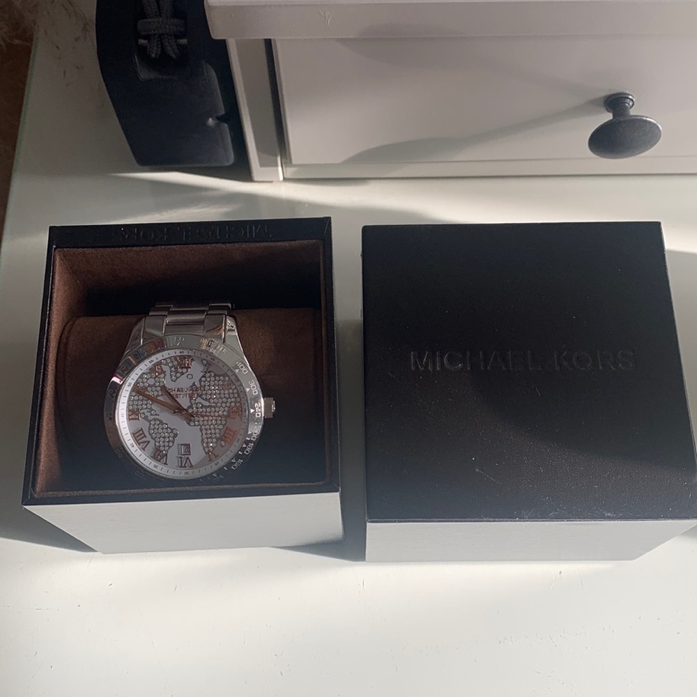 Silver Michael Kors watch with continents on face